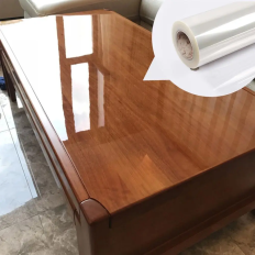 Transparent glossy adhesive film for protecting paint, tables
