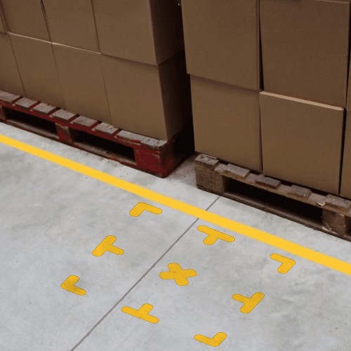 Grid of pallet locations with yellow corners, T and cross markers in a warehouse