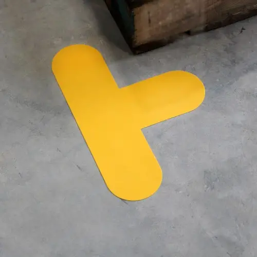 Yellow 30x20 cm T floor marker fitted on a warehouse floor