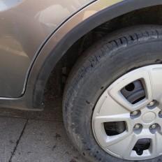 Self-adhesive protective rubber trim for car wheel arches