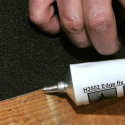 Sealant edges to prevent non-slip lifting in high pass areas